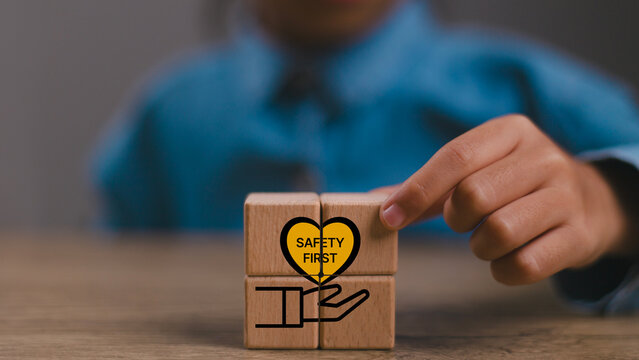 Safety first symbols, work safety, caution work hazards, danger surveillance, zero accident concept. Wooden cubes with smart grey background. Employees safety awareness at workplace. Safety banner.