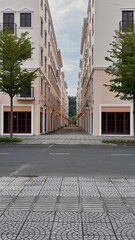 Naklejka premium Symmetrical view of a quiet urban street between elegant modern apartment buildings with soft pastel facades.