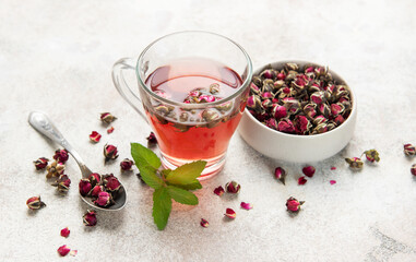 Rose tea infusion with dried buds and fresh mint leaf © Olena Rudo