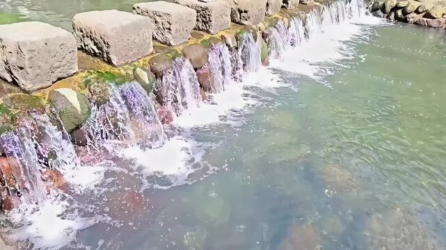 Stone barrier dam with steppingstones on river, Flowing Water, Small Waterfall Stream, Civil Ecology Architecture, Slow Motion