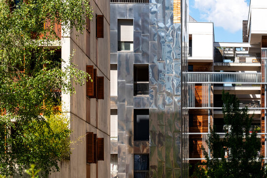 Reflective facade details frame La Confluence apartments in Lyon, where residential architecture meets urban housing and balconies in France