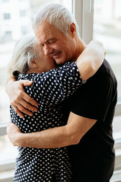 Senior man and woman sharing hug