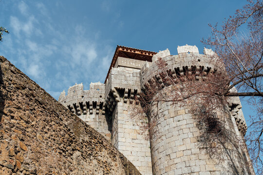 Medieval castle of Granadilla stone towers with blue sky low angle