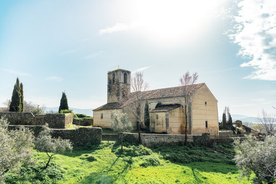 Rural church with bell tower and green field in Extremadura Spain