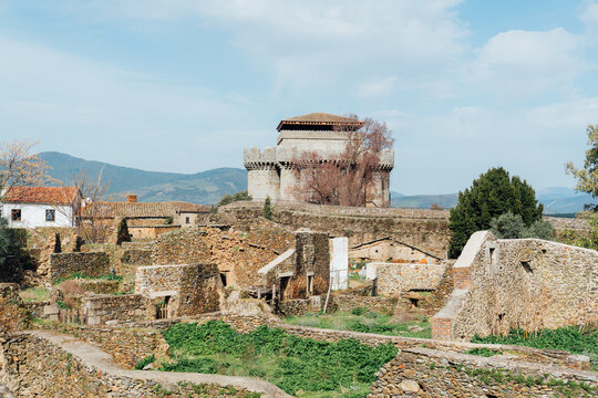 Medieval tower above stone ruins in Granadilla Extremadura Spain
