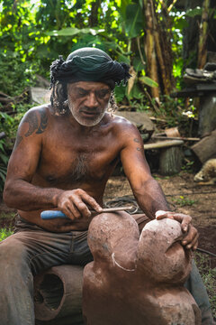 Indigenous artist carves a traditional stone sculpture