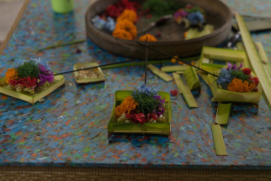 Colorful Balinese canang sari flower offerings on table, Munduk, Bali