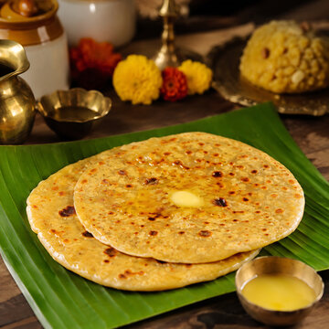 Puran poli served with ghee on a banana leaf, traditional Maharashtrian festival food, rustic Indian kitchen background, warm natural light