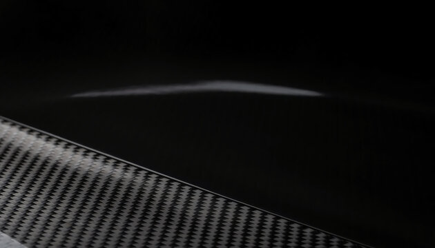 Macro Shot of Glossy Black Carbon Fiber Texture with Diagonal Weave Pattern and Elegant Light Reflections, Sleek High-Tech Composite Material Background for Automotive and Industrial Design