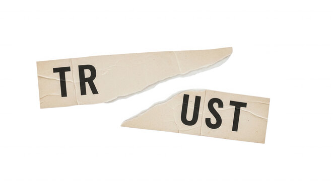 Two torn pieces of beige paper with the black letters tr and ust printed on them, isolated against a solid black background