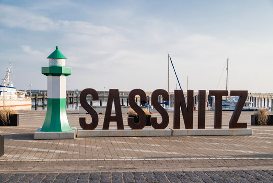 Germany  Sassnitz , 8 March 2026, maLarge metal lettering spelling "SASSNITZ" stands next to a green and white decorative lighthouse model at the city harbor in Sassnitz, R&uuml;gen Island, Germany.