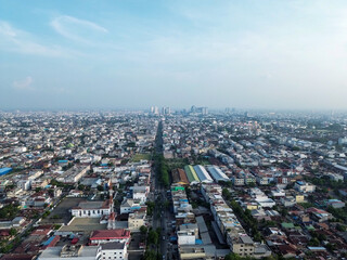 Obraz premium Aerial Panoramic View of Sprawling Southeast Asian City with Boulevard and Distant Skyline