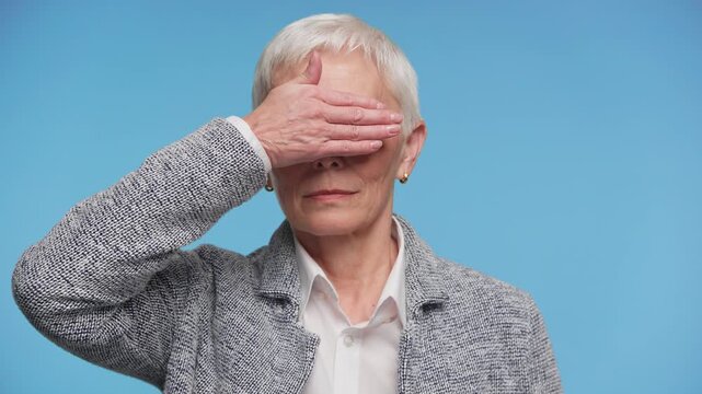 Senior Woman Covering Eyes Gesture on Blue Background