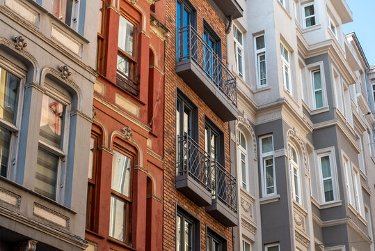 A vintage building with windows and small bay windows.