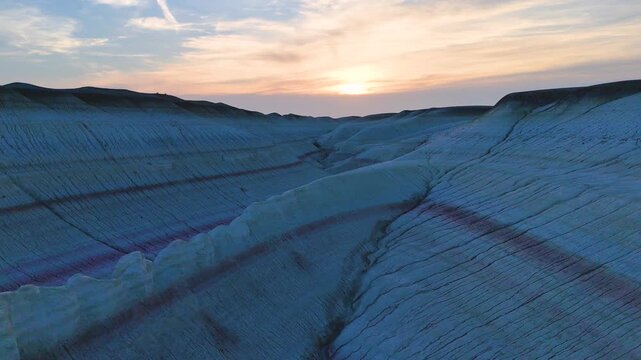 multicolored canyon at sunset Kyzylkup is a natural landmark in the Mangystau region of Kazakhstan. It is a group of colorful hills with multicolored layered slopes that resemble the Italian dessert t