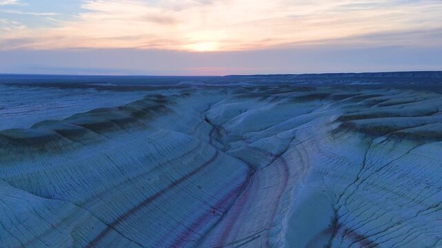 multicolored canyon at sunset Kyzylkup is a natural landmark in the Mangystau region of Kazakhstan. It is a group of colorful hills with multicolored layered slopes that resemble the Italian dessert t