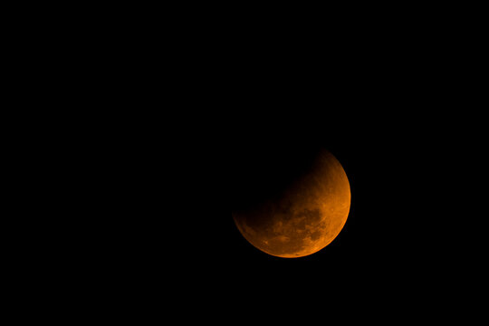 Partial Lunar Eclipse with Shadowed Moon Detail Against Night Sky