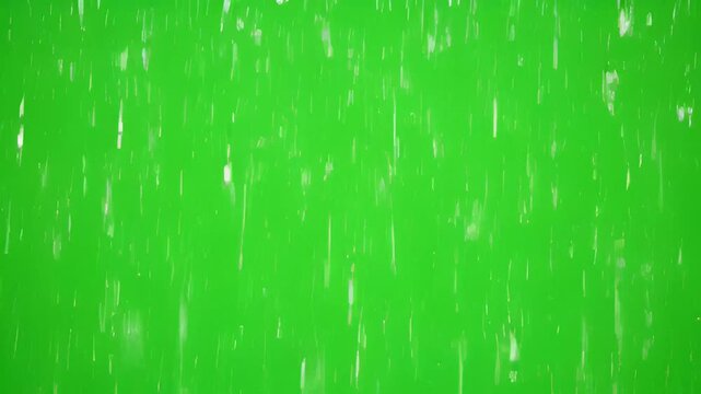 Rain falls heavily outside on a green screen background at night