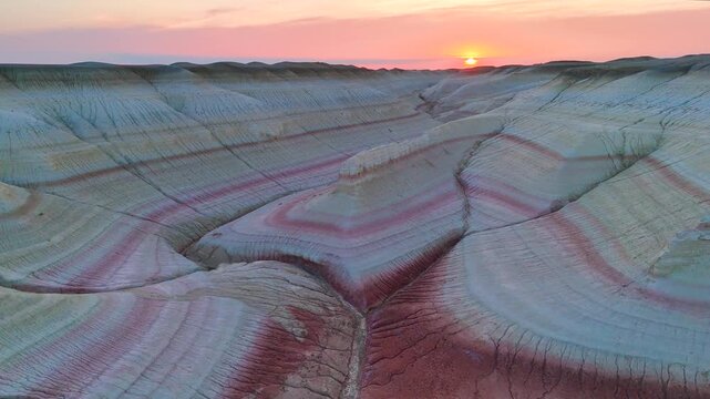 multicolored canyon at sunset Kyzylkup is a natural landmark in the Mangystau region of Kazakhstan. It is a group of colorful hills with multicolored layered slopes that resemble the Italian dessert t