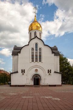 White church with golden dome stands under blue sky