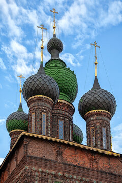 Green domes gleam above red brick towers
