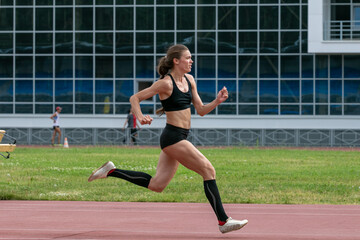Fototapeta premium Female athlete running up before triple jump