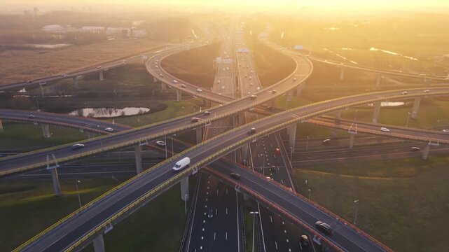 Smooth traffic flow on modern intersecting highways in Netherlands at golden sunshine