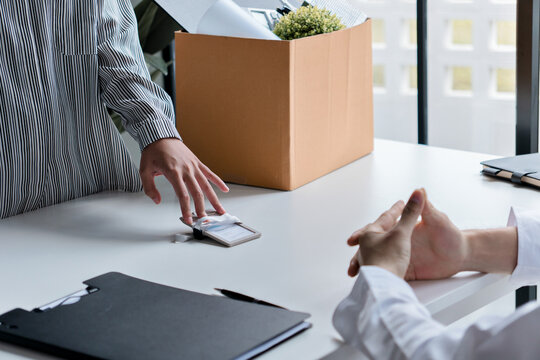 Resignation concept.Businesswoman packing Stuff with cardboard box for quit a job