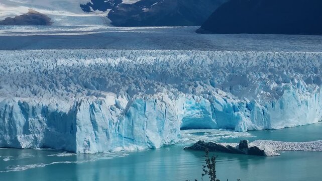 Sunlit panorama of Perito Moreno Glacier in Patagonia, Argentina, where white and pale blue ice walls shimmer above turquoise waters. A striking view of one of South America&rsquo;s natural wonders