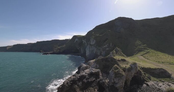 static shot of the tropical coastline viewable from Kinbane Castle
