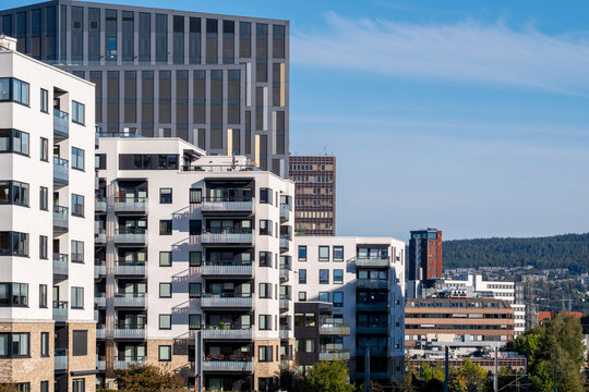 Residential apartment building rises through Loren with balcony rows and facade patterns set against urban architecture in Oslo, Norway
