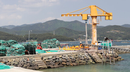 Fishing Port with Gantry Crane and Stacked Nets on a Coastal Day © L.Z.C Photographer