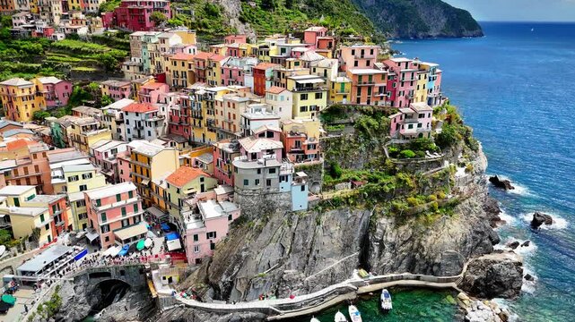 High-detail drone close-up of Manarola houses cascading to the Ligurian Sea, Cinque Terre UNESCO village, Italian Riviera, Italy