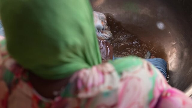 Close up of African woman hand washing clothes in basin, April 25, 2026, Chad, N Djamena