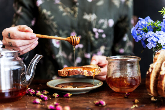 Honey drizzling on rustic bread