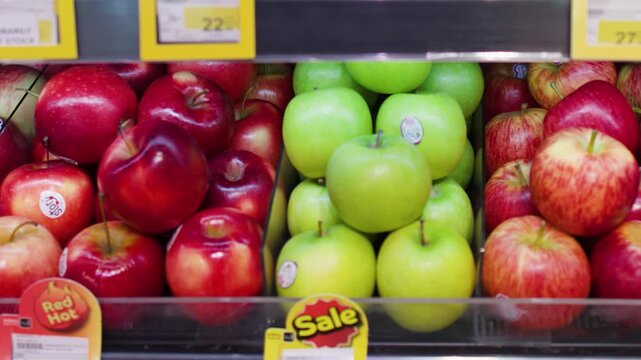 Close Up of Fresh Red and Green Apples on Supermarket Shelves
