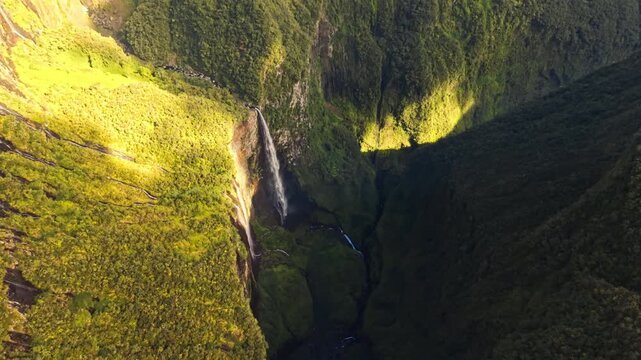 Aerial view of Trou de Fer canyon waterfall sunlight