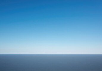 Obraz premium Expansive blue sky backdrop meeting a flat, subtle landscape at the perfect horizontal line. A serene and boundless natural background, sunny, blue, perspective