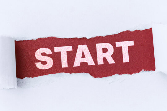 Torn white paper revealing red background with START text. Concept for business launch, new project beginning, and startup motivation.
