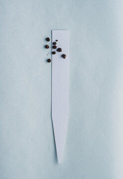 Black and allspice peppercorns on paper perfume blotters. Olfactory concept 