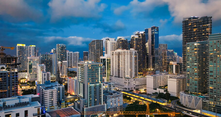 Fototapeta premium Miami skyline at dusk showing urban skyscrapers and transport