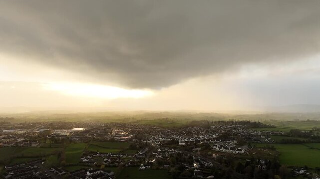 Thunderstorm dramatic base hanging low over cookstown at sunset by drone