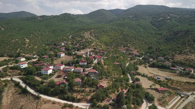 Drone orbit shot of Cide coastal town with mosque and traditional houses, Kastamonu, Turkey.