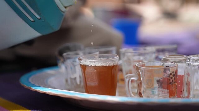 Traditional Chadian tea being poured into glasses, April 25, 2026, Chad, N Djamena