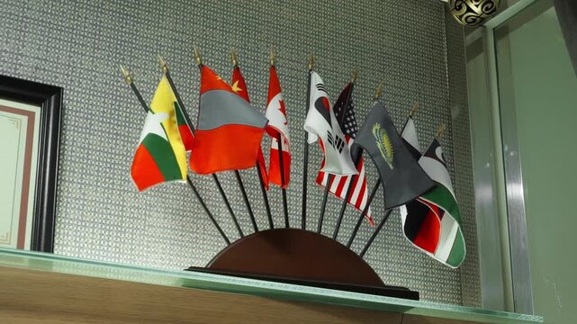 A table stand with small flags of different countries.