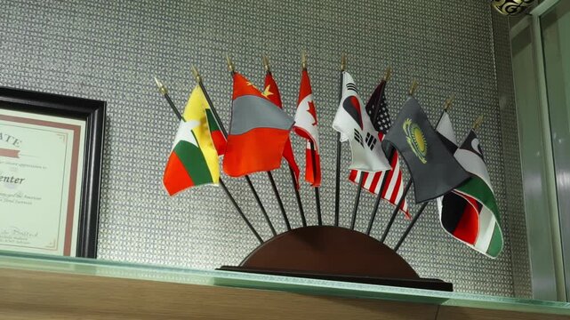A table stand with small flags of different countries.
