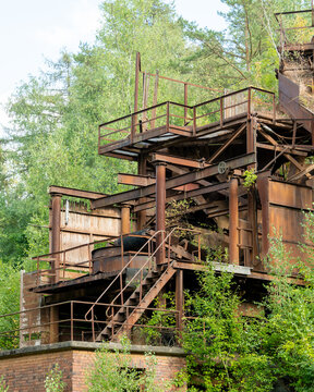 Abandoned industrial factory infrastructure decaying in overgrown nature