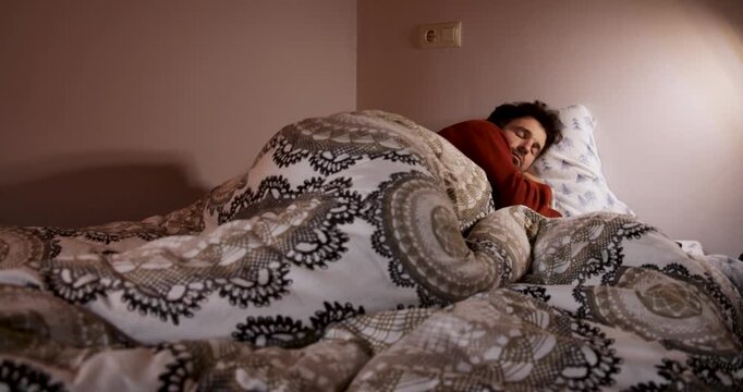 Sleepy man reading on e reader before sleeping