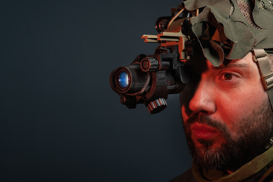 Professional night vision device on tactical operator with copy space and high tech image intensifier components
