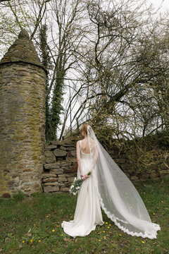 bride veil wedding dress bouquet medieval architecture